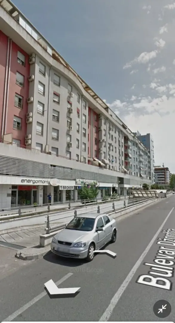View of the exterior of an apartment building and street.