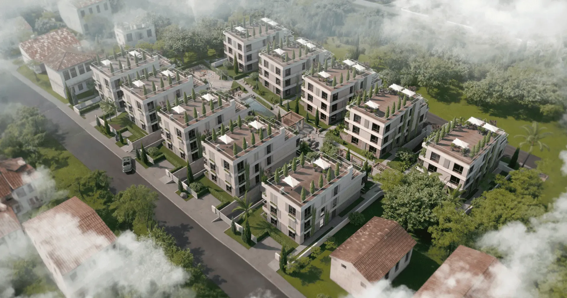 Pogled iz vazduha na kompleks modernih stambenih zgrada sa uređenim krovnim terasama.