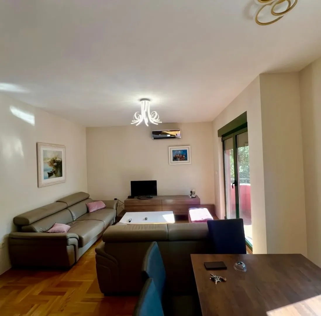 Living room with a seating set, TV, and dining table.