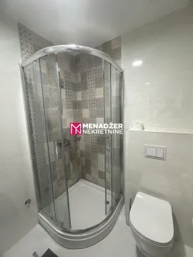 Modernly equipped bathroom with a shower cabin and toilet. - image 6