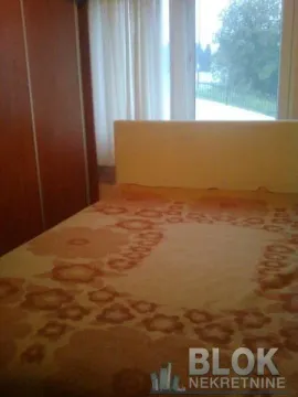 Bedroom with a bed and wardrobe. - image 9