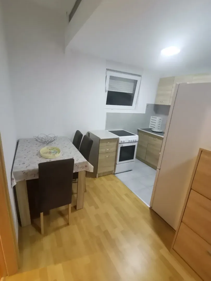 Kitchen with a small dining area and basic appliances.