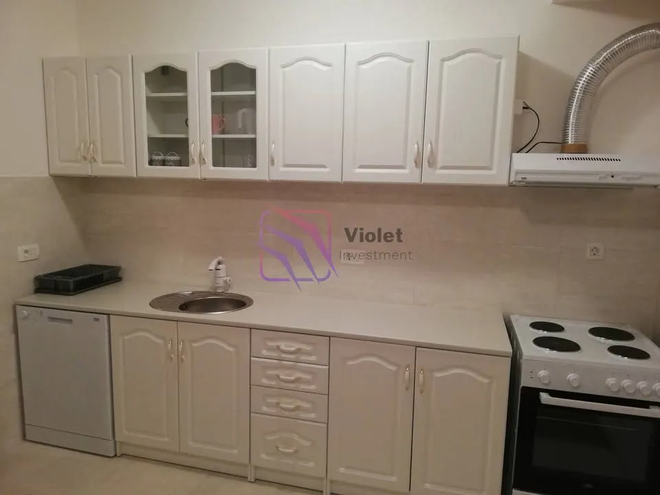 Kitchen with white cabinets, a sink, and built-in appliances.