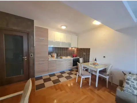 Kitchen with dining area and wooden flooring. - image 2