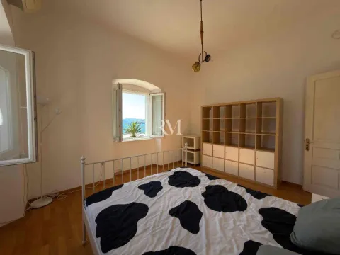 Bedroom with a bed and a sea view. - image 4