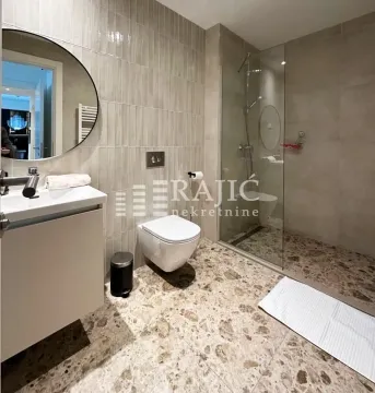 Modern bathroom with walk-in shower and washbasin. - image 2