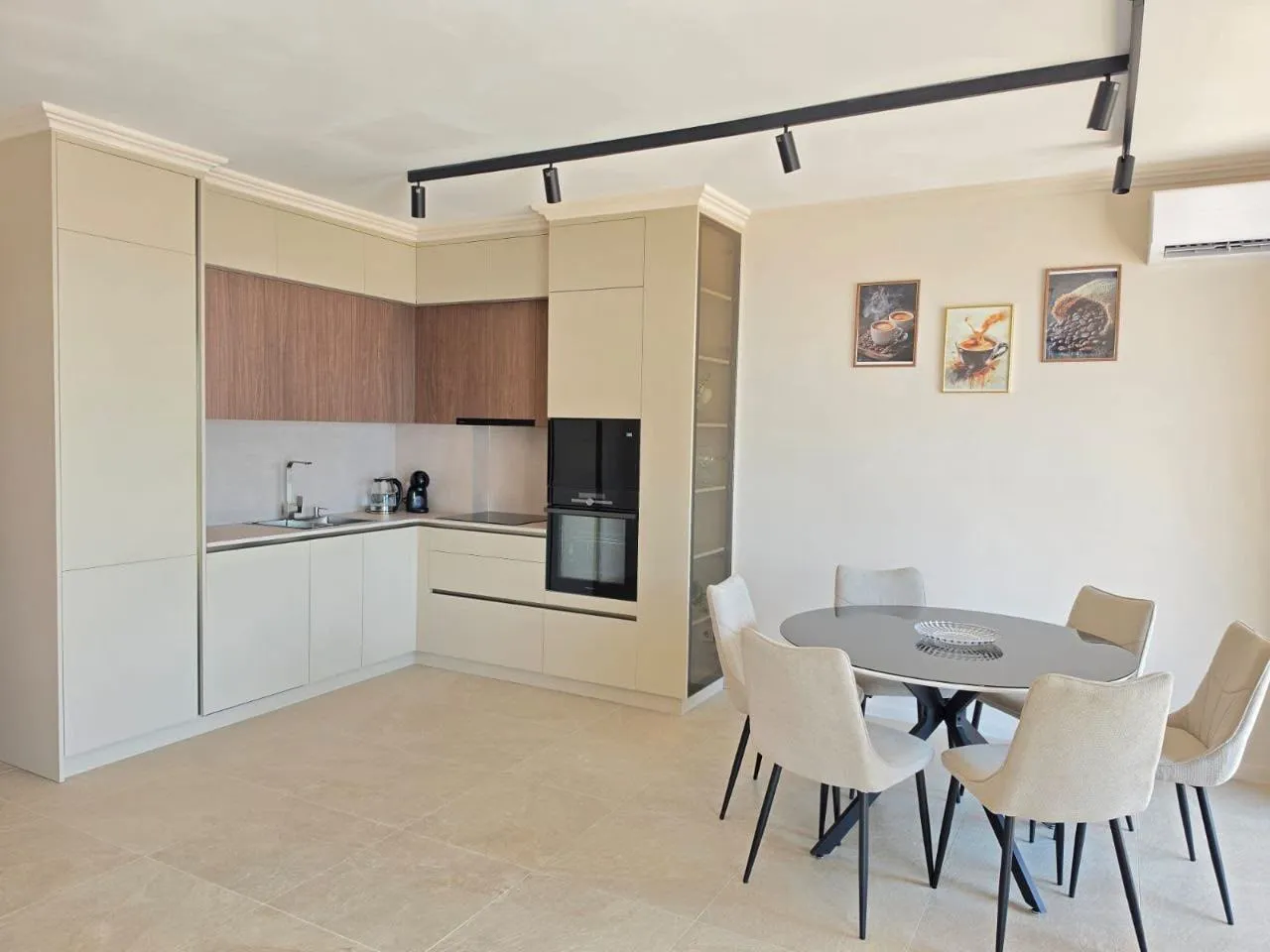 Modern kitchen with dining area in bright tones.