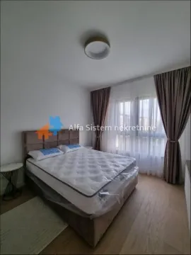 Furnished bedroom with a double bed and a window with curtains. - image 12