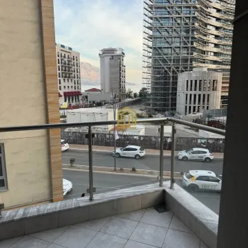 View from the balcony overlooking the street and surrounding buildings under construction. - image 2