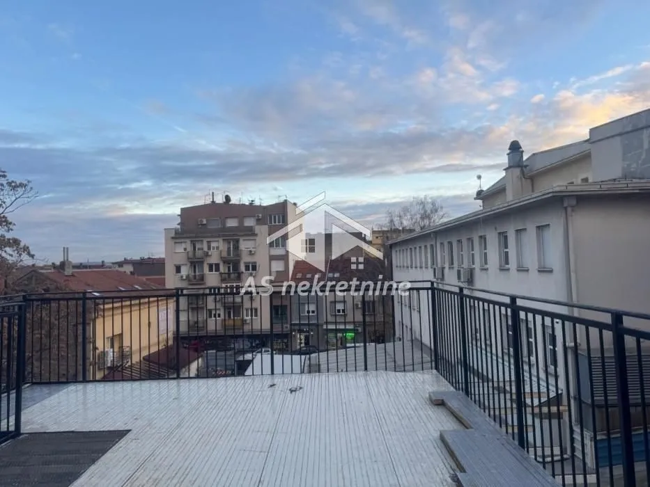 View of city buildings from a spacious terrace.