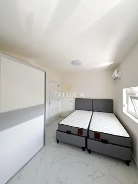 Bedroom with two beds and a white wardrobe. - image 11