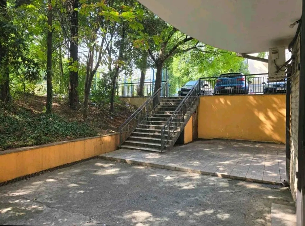 Exterior of the building with stairs and courtyard.