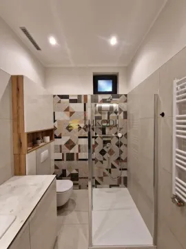 Modern bathroom with a shower cabin and built-in units. - image 18