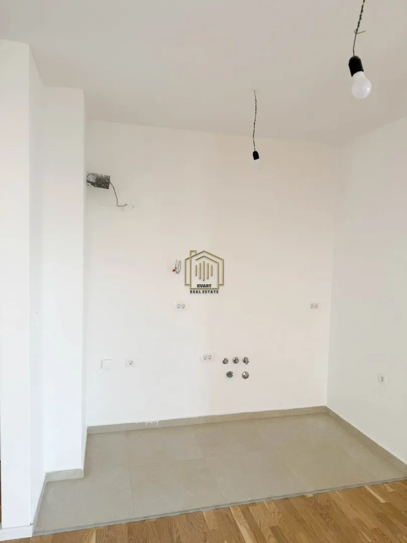 Part of the property with kitchen connections and tiled flooring.