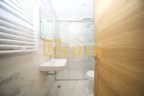 Modernly equipped bathroom with a walk-in shower and washbasin. - image 4
