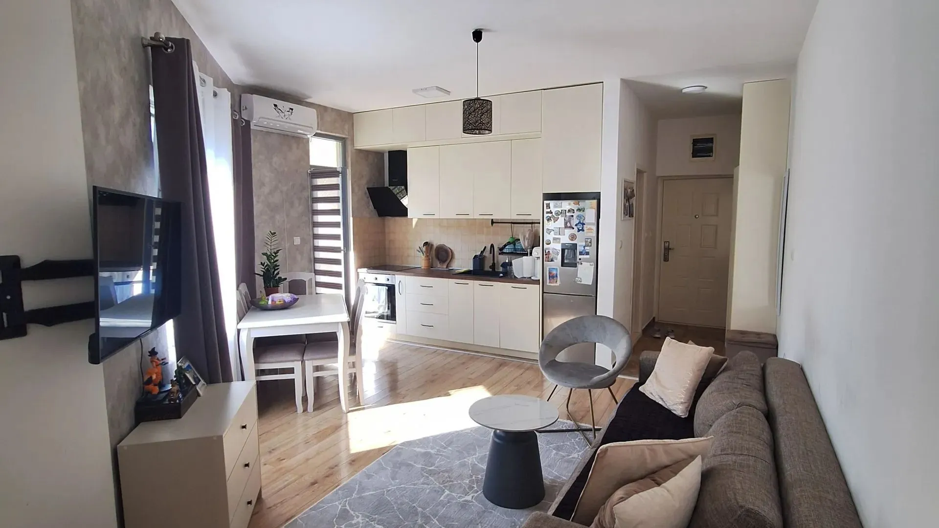 Open-plan living room with dining area and kitchen.