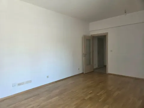Empty room with parquet flooring and white walls. - image 6