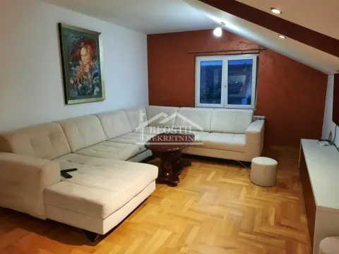 Living room with a sectional sofa and parquet flooring in the attic. - image 2