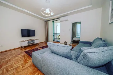 Living room with sofa, TV, and access to the terrace. - image 2