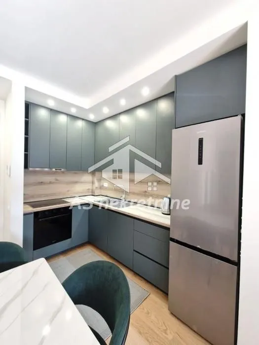 Modern kitchen with grey cabinets and built-in appliances.