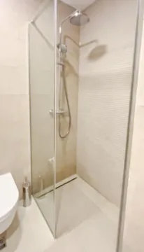 Modernly equipped bathroom with a walk-in shower. - image 9