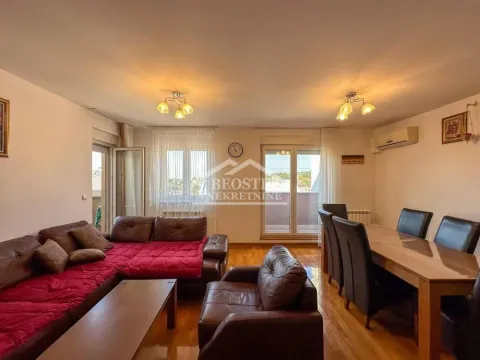 Spacious living room with a sofa set and a dining table. - image 2