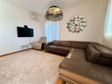 Living room with a sectional sofa, TV, and decorative wall mirror. - image 3