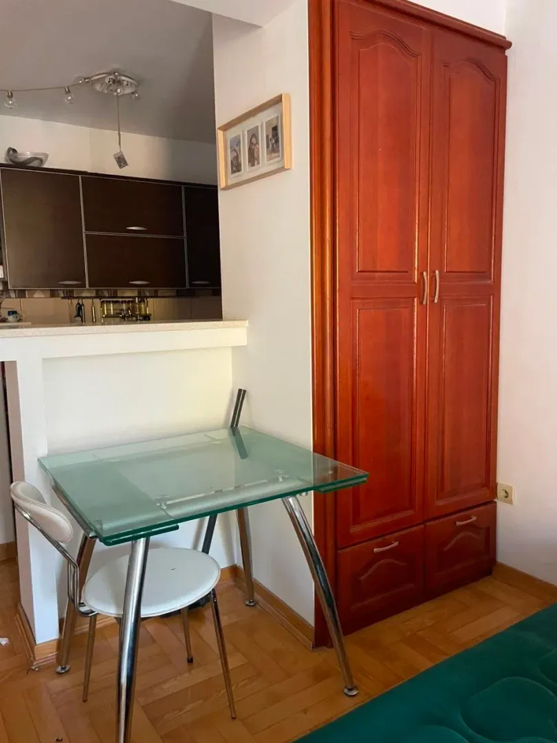 Living room with a dining table and a built-in wardrobe.