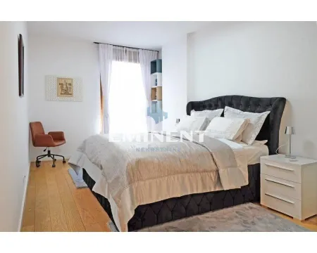 Spacious bedroom featuring a double bed, a desk chair, and a white nightstand. - image 7
