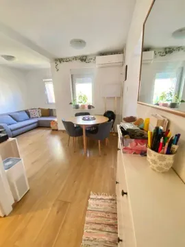 Living room with a dining table and a corner sofa. - image 3