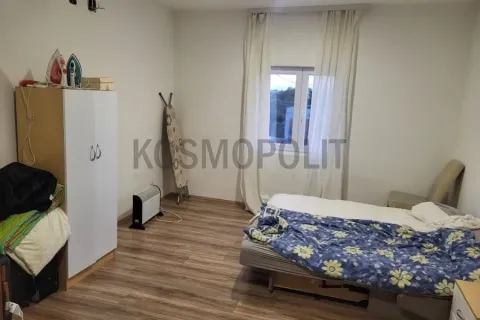 Furnished bedroom with a bed, wardrobe, and window. - image 8