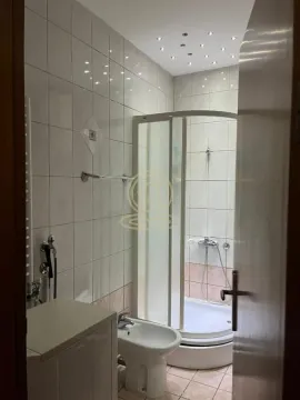 Bathroom equipped with a shower cabin, bidet, and ceramic wall tiles. - image 9