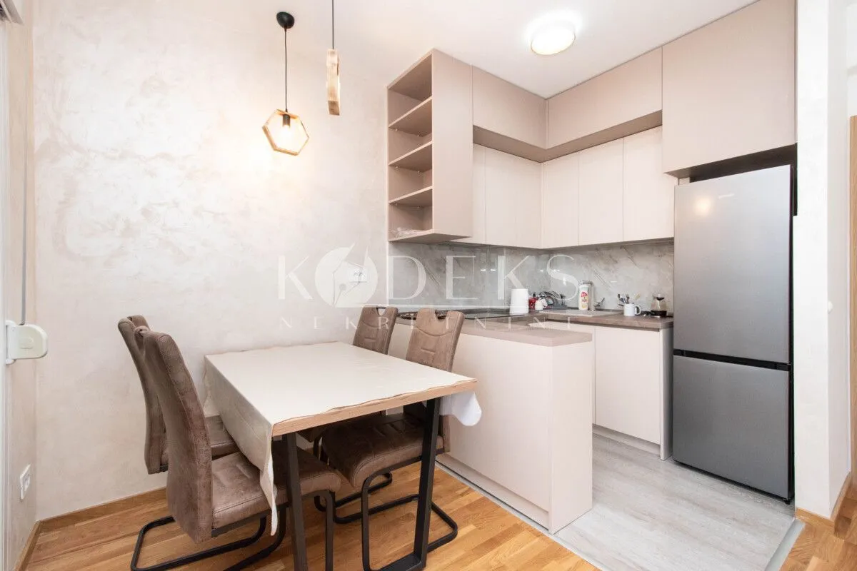 Kitchen with a dining area and modern light-toned cabinetry.