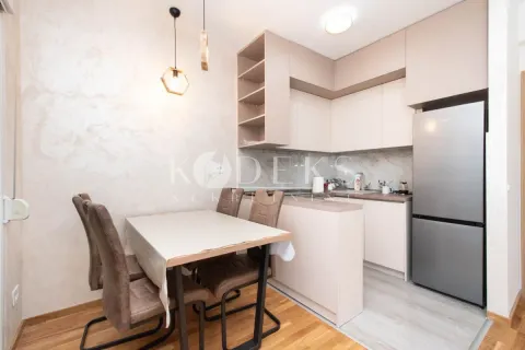 Kitchen with a dining area and modern light-toned cabinetry. - image 3