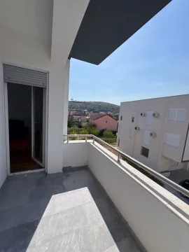 Spacious bright terrace with metal railing and neighborhood view. - image 11