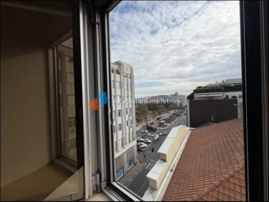 View through the window of the city street and surrounding buildings.