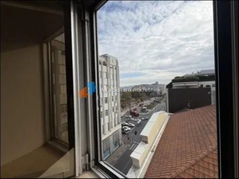View through the window of the city street and surrounding buildings. - image 19