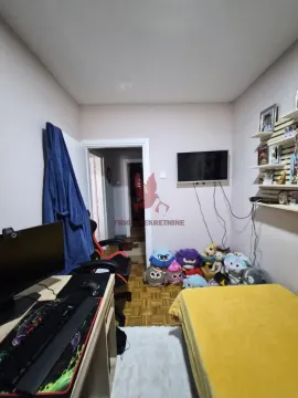 Small bedroom with a bed, a desk, and a wall-mounted TV. - image 6