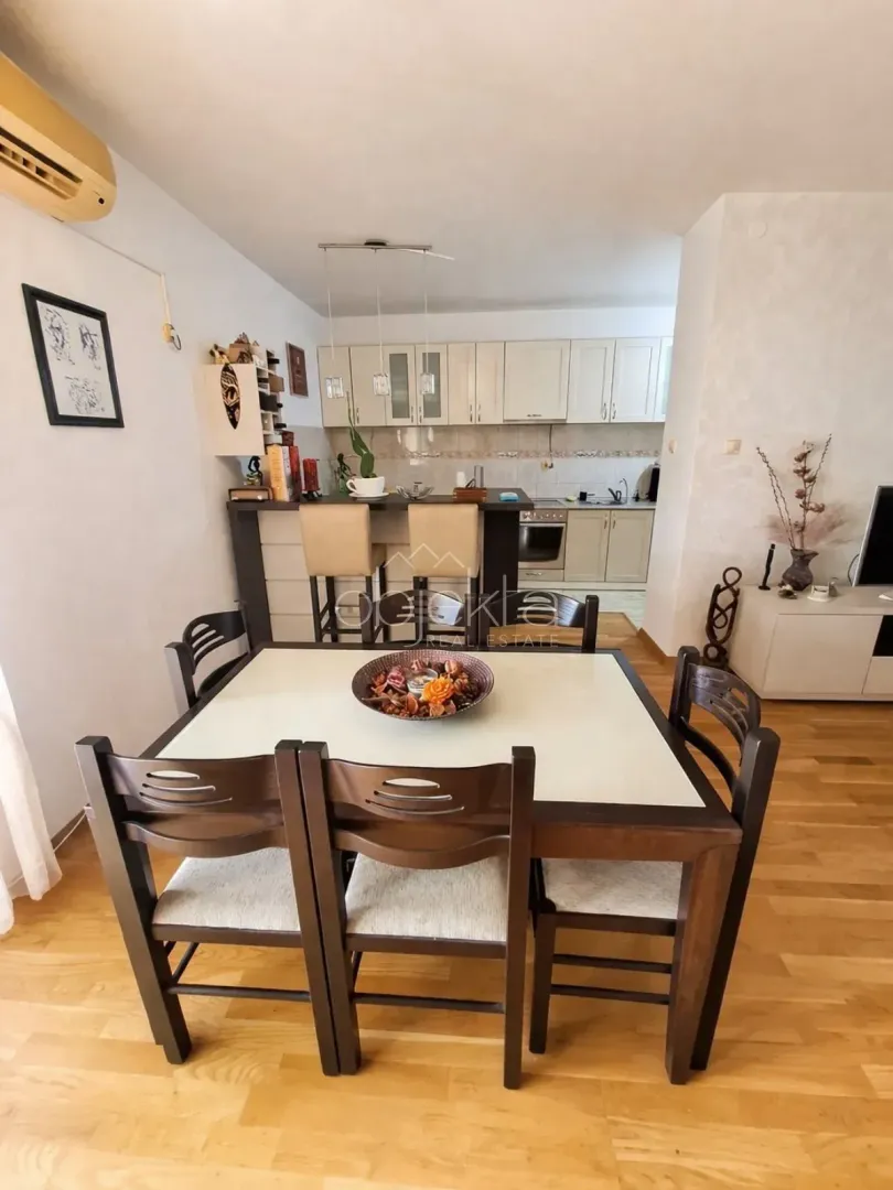 Living room with a dining area and a kitchen in the background.
