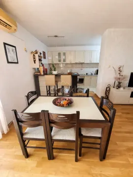 Living room with a dining area and a kitchen in the background. - image 5
