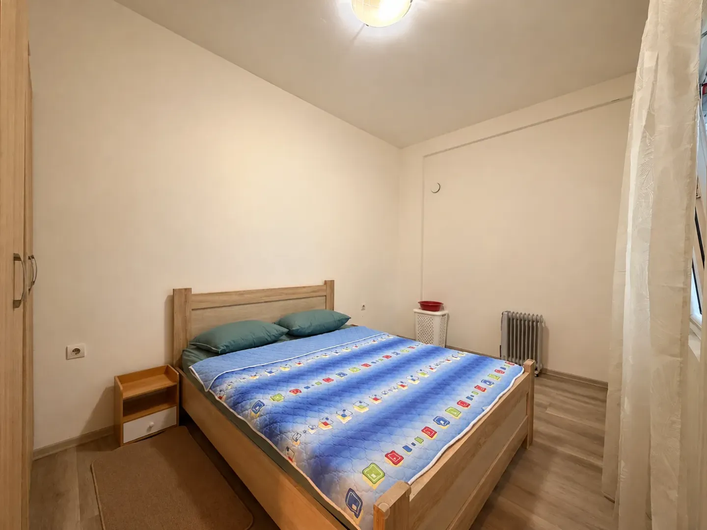 Furnished bedroom with a double bed and wardrobe.
