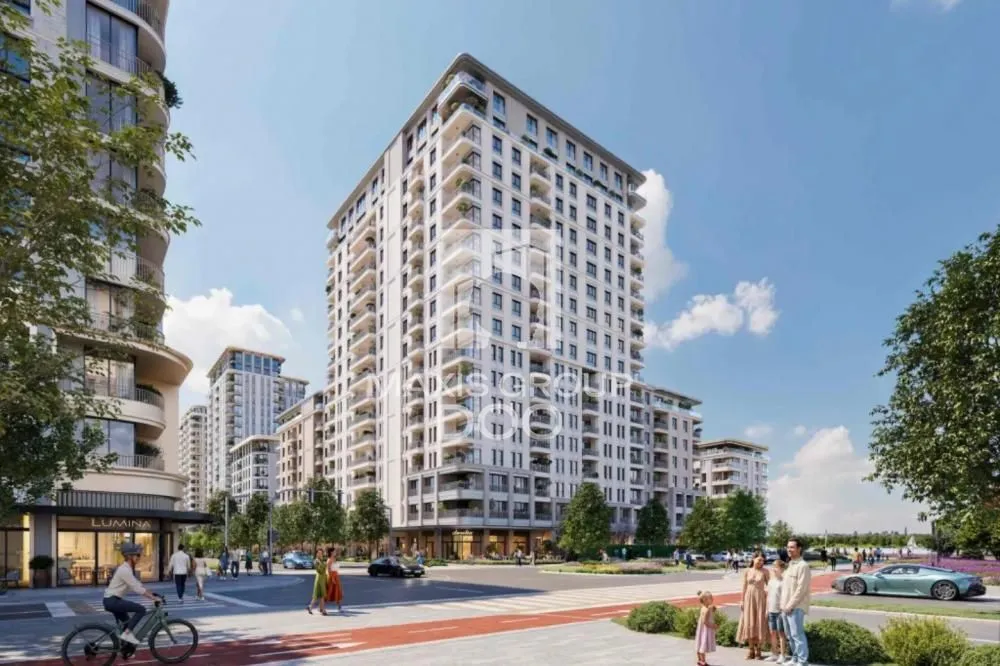 Exterior view of a modern residential building with a landscaped square and promenade.