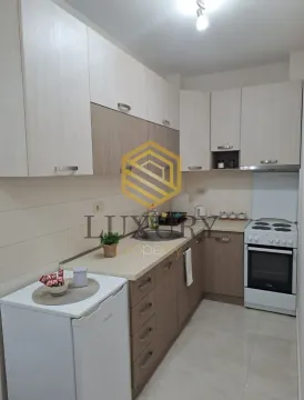 Smaller kitchen with wood-tone cabinets and a stove. - image 10