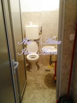 Smaller bathroom with a toilet and a sink. - image 7
