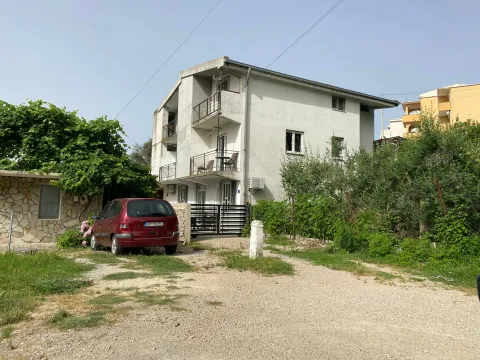 Exterior view of the house with a yard and a parked car. - image 12