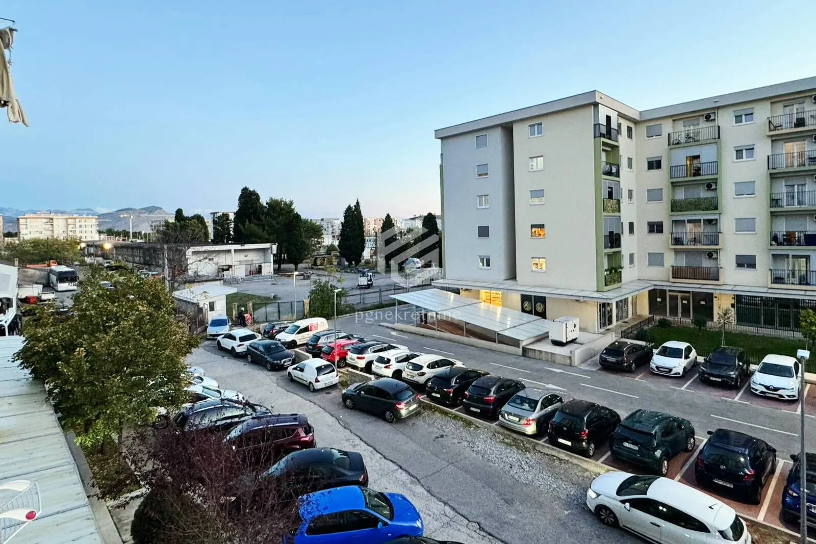 View from the terrace overlooking the parking lot and surrounding buildings.