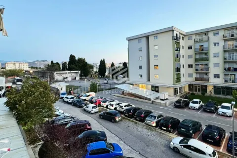View from the terrace overlooking the parking lot and surrounding buildings. - image 2