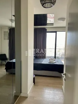 View from the hallway into a furnished bedroom with a double bed and access to the terrace. - image 2