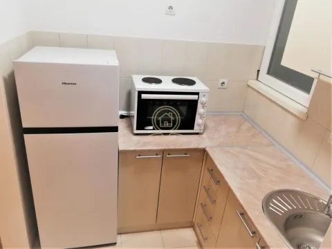 Small kitchen equipped with a refrigerator, stove, and sink. - image 5
