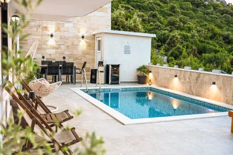 Terrace with a swimming pool, seating set, and sun loungers. - image 3